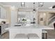 Modern kitchen features a large island with seating, stainless appliances, and open layout adjacent to staircase at 6154 Marsh Trail Dr, Odessa, FL 33556