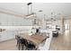 Open-concept kitchen and dining area, featuring modern appliances, island seating, and stylish design at 6154 Marsh Trail Dr, Odessa, FL 33556