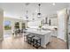 Spacious kitchen with white cabinets, stainless steel appliances, and a large center island with seating at 6154 Marsh Trail Dr, Odessa, FL 33556
