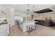 Spacious kitchen with seating overlooks the dining and living area, featuring modern finishes and appliances at 6154 Marsh Trail Dr, Odessa, FL 33556