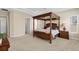 Bright primary bedroom with canopy bed, a ceiling fan, and views to the backyard at 6154 Marsh Trail Dr, Odessa, FL 33556
