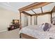 Spacious bedroom with decorative canopy bed and entertainment center at 6154 Marsh Trail Dr, Odessa, FL 33556