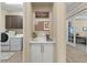 Mud room features a countertop, cabinets, personalized decorations and signage leading to the laundry room and home office at 6154 Marsh Trail Dr, Odessa, FL 33556