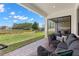 Comfortable covered patio featuring brick pavers and a seating area with picturesque outdoor views at 6154 Marsh Trail Dr, Odessa, FL 33556