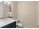 Elegant powder room featuring a black vanity cabinet, white countertop, and sleek silver faucet at 6154 Marsh Trail Dr, Odessa, FL 33556