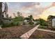 Serene backyard featuring a brick pathway, mature trees, and a garden with an bee hive, ideal for outdoor enjoyment at 6251 4Th S Ave, St Petersburg, FL 33707