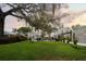 Lush backyard with a spacious lawn, inviting seating areas, and mature trees, perfect for relaxing and enjoying the outdoors at 6251 4Th S Ave, St Petersburg, FL 33707