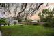 Spacious backyard with a sprawling lawn, mature trees, and a swing, ideal for outdoor recreation and relaxation at 6251 4Th S Ave, St Petersburg, FL 33707