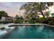 A picturesque backyard featuring a pristine pool, plenty of lounge chairs, and mature landscaping at 6251 4Th S Ave, St Petersburg, FL 33707
