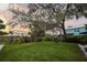 Lush backyard with a sprawling lawn, mature trees, and a charming swing, ideal for outdoor activities and relaxation at 6251 4Th S Ave, St Petersburg, FL 33707