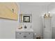Cozy bathroom featuring a sink with gray cabinets, a decorative mirror and a cabinet for storage at 6251 4Th S Ave, St Petersburg, FL 33707