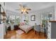 Cozy bedroom featuring hardwood floors, a ceiling fan, and multiple windows providing ample natural light at 6251 4Th S Ave, St Petersburg, FL 33707