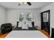 Bedroom featuring two windows, hardwood floors, a ceiling fan and stylish decor at 6251 4Th S Ave, St Petersburg, FL 33707