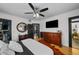 Primary bedroom with hardwood floors, stylish decor, an ensuite bath and a walk-in closet at 6251 4Th S Ave, St Petersburg, FL 33707