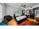 Bedroom with hardwood floors, a ceiling fan, stylish decor, and a closet at 6251 4Th S Ave, St Petersburg, FL 33707