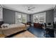 Bedroom featuring a bed, desk, and ample natural light from the multiple windows at 6251 4Th S Ave, St Petersburg, FL 33707