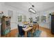 Stylish dining room with rustic table, modern light fixture, and ample natural light at 6251 4Th S Ave, St Petersburg, FL 33707