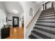 Elegant foyer with decorative stairs, hardwood floors and natural light at 6251 4Th S Ave, St Petersburg, FL 33707