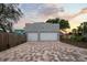 Detached two-car garage with a brick driveway, providing ample parking and storage space for vehicles and belongings at 6251 4Th S Ave, St Petersburg, FL 33707