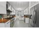 Modern kitchen with white cabinets, butcher block counters, and stainless steel appliances at 6251 4Th S Ave, St Petersburg, FL 33707