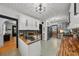 Open kitchen with white cabinets, stainless steel appliances, butcher block countertops, and decorative tile flooring at 6251 4Th S Ave, St Petersburg, FL 33707