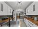 Modern kitchen features stainless appliances, wood counters, designer tile floors, and adjacent dining area at 6251 4Th S Ave, St Petersburg, FL 33707