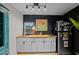 Modern kitchenette boasts butcher block countertop, sleek black refrigerator, and flamingo wall art at 6251 4Th S Ave, St Petersburg, FL 33707