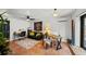 Bright living room features a ceiling fan, brick floors, and desk with natural light at 6251 4Th S Ave, St Petersburg, FL 33707