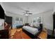 Comfortable main bedroom features hardwood floors, lots of windows, and a modern ceiling fan at 6251 4Th S Ave, St Petersburg, FL 33707