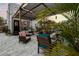 The patio's multiple seating areas are ideal for relaxing in this lush outdoor setting underneath a shaded pergola at 6251 4Th S Ave, St Petersburg, FL 33707