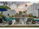 Lounge poolside in the backyard, featuring a sparkling pool, lounge seating, and a private fenced yard at 6251 4Th S Ave, St Petersburg, FL 33707