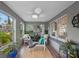 A bright, sunlit porch with cozy seating and plants, creating a tranquil space to relax and enjoy the outdoors at 6251 4Th S Ave, St Petersburg, FL 33707