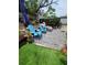 Serene backyard featuring an artificial grass area, pavers, and lounge chairs, perfect for relaxation at 6318 Ridge Crest Dr, Port Richey, FL 34668