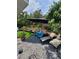 Backyard patio with pavers, lounge chairs, and outdoor furniture with green artificial grass at 6318 Ridge Crest Dr, Port Richey, FL 34668