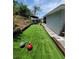 Artificial turf backyard with landscaping, patio, and stepping stone walkway at 6318 Ridge Crest Dr, Port Richey, FL 34668