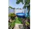 Private backyard featuring a pool, mature landscaping, and a serene outdoor setting at 6318 Ridge Crest Dr, Port Richey, FL 34668