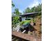 Backyard area with lounge chairs, artificial turf and decorative landscape at 6318 Ridge Crest Dr, Port Richey, FL 34668