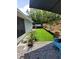 Backyard featuring artificial turf, gravel, and stepping stones, offering a low-maintenance outdoor space at 6318 Ridge Crest Dr, Port Richey, FL 34668