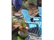 Close-up shot features the backyard's colorful decor and inviting blue chairs at 6318 Ridge Crest Dr, Port Richey, FL 34668