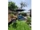 Cozy backyard retreat featuring vibrant blue chairs, a relaxing lounge chair, and lush landscaping at 6318 Ridge Crest Dr, Port Richey, FL 34668