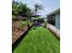 Beautiful backyard featuring an artificial lawn, seating area, and a privacy fence at 6318 Ridge Crest Dr, Port Richey, FL 34668