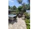 Spacious backyard with patio, fire pit, lush garden and outdoor dining area at 6318 Ridge Crest Dr, Port Richey, FL 34668