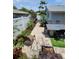 Inviting backyard patio with outdoor dining, garden path, and a beautifully landscaped garden at 6318 Ridge Crest Dr, Port Richey, FL 34668