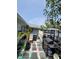 Backyard with stone pavers, grill, trailer and lush landscaping at 6318 Ridge Crest Dr, Port Richey, FL 34668