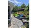 Landscaped backyard featuring artificial turf, lounge chairs and stone pathway at 6318 Ridge Crest Dr, Port Richey, FL 34668