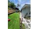 Artificial turf backyard with landscaping, patio, and stepping stone walkway at 6318 Ridge Crest Dr, Port Richey, FL 34668