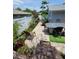 Inviting backyard patio with outdoor dining, garden path, and a beautifully landscaped garden at 6318 Ridge Crest Dr, Port Richey, FL 34668