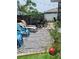 Backyard patio with pavers, lounge chairs, and outdoor furniture with stone landscaping at 6318 Ridge Crest Dr, Port Richey, FL 34668