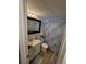 Well-lit bathroom with a white vanity, toilet, shower-tub combo, nautical shower curtain, and tile floors at 6318 Ridge Crest Dr, Port Richey, FL 34668