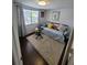 Bright bedroom with daybed, neutral rug, hardwood floors, and lots of natural light at 6318 Ridge Crest Dr, Port Richey, FL 34668